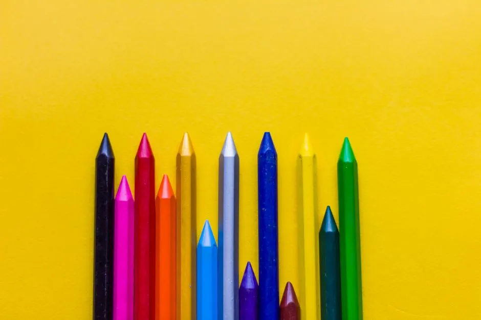 An assortment of colored crayons in a row